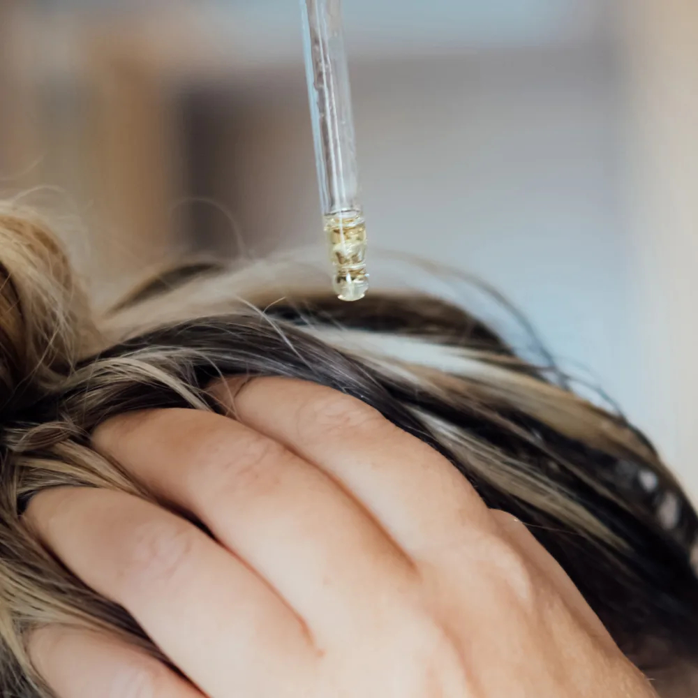 oil being applied to hair