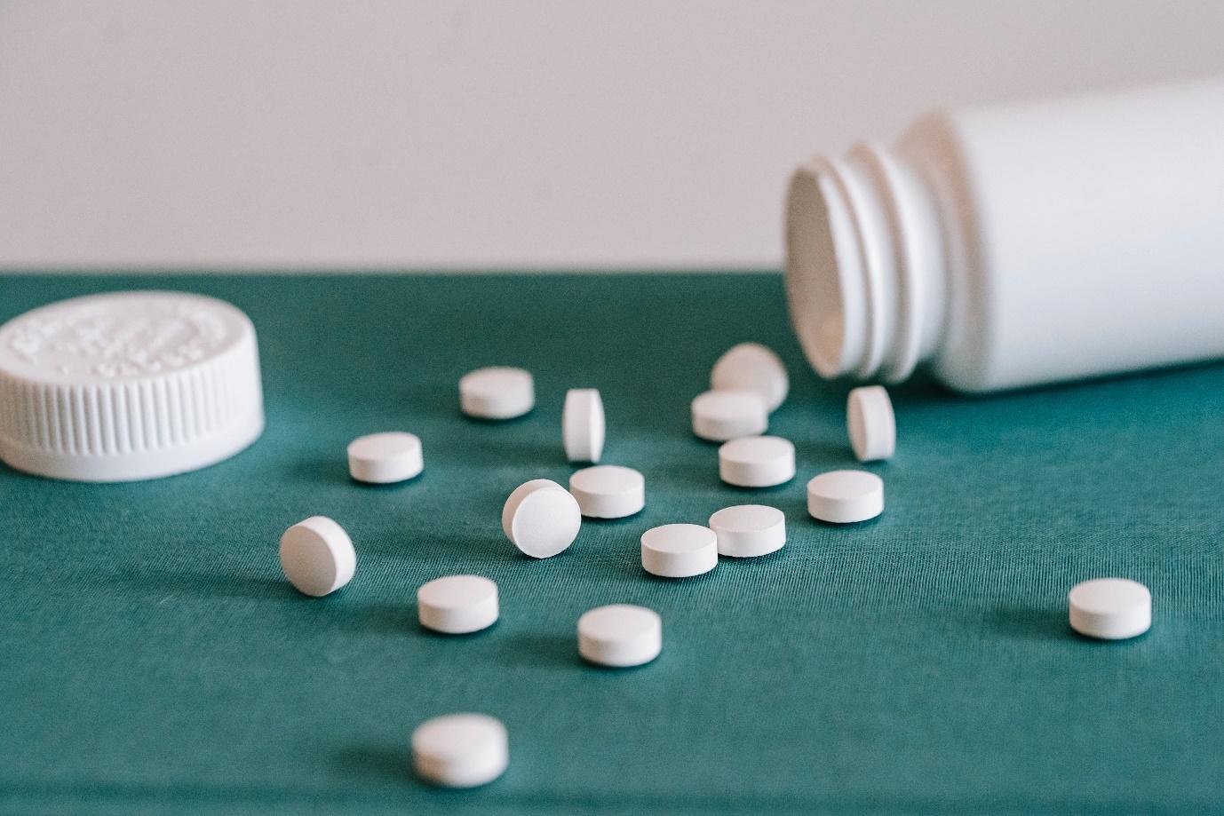 tablets and an open bottle of tablets